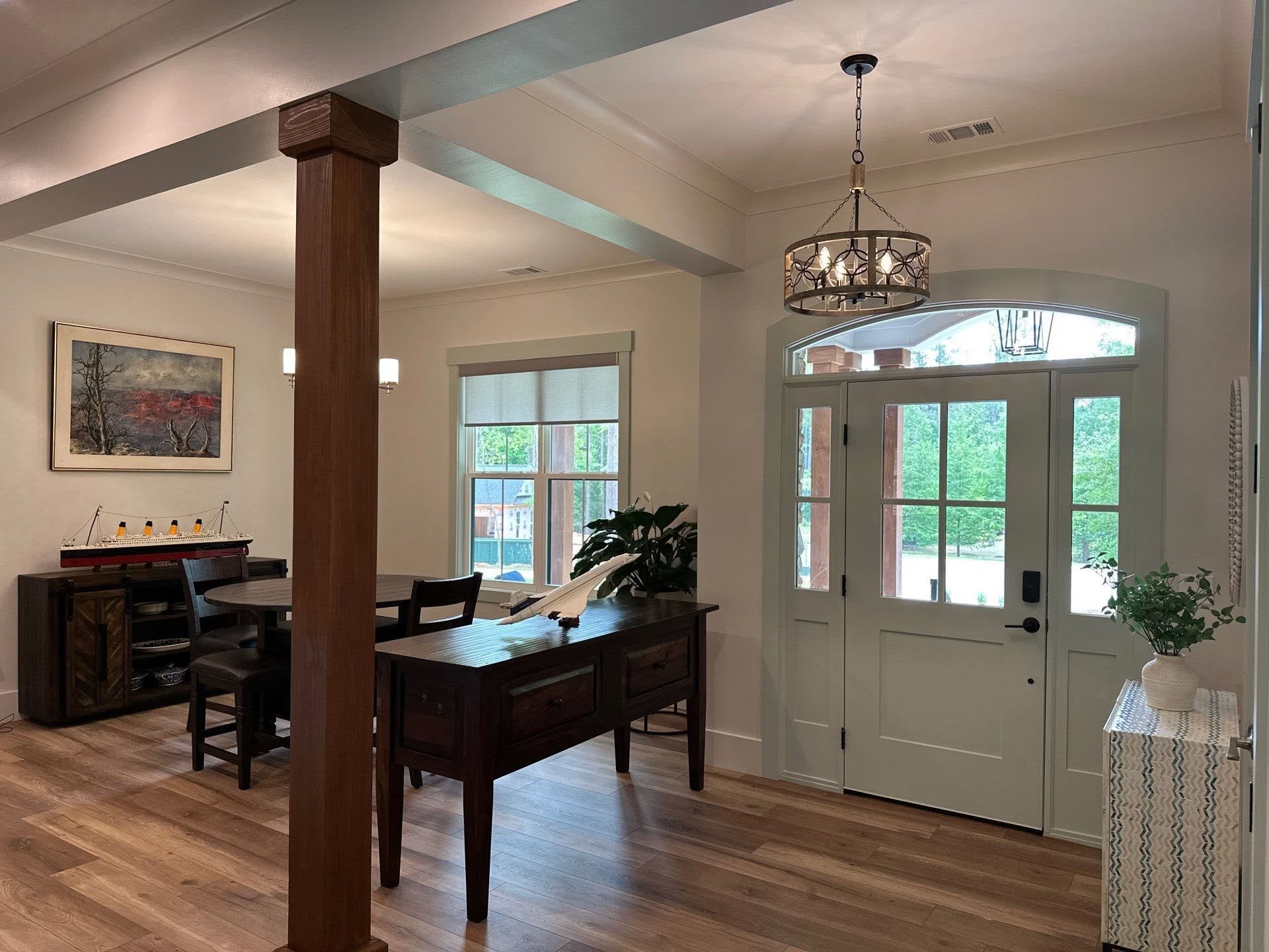 Finished dining and entry space by Atlas Construction with custom wood details and layered lighting